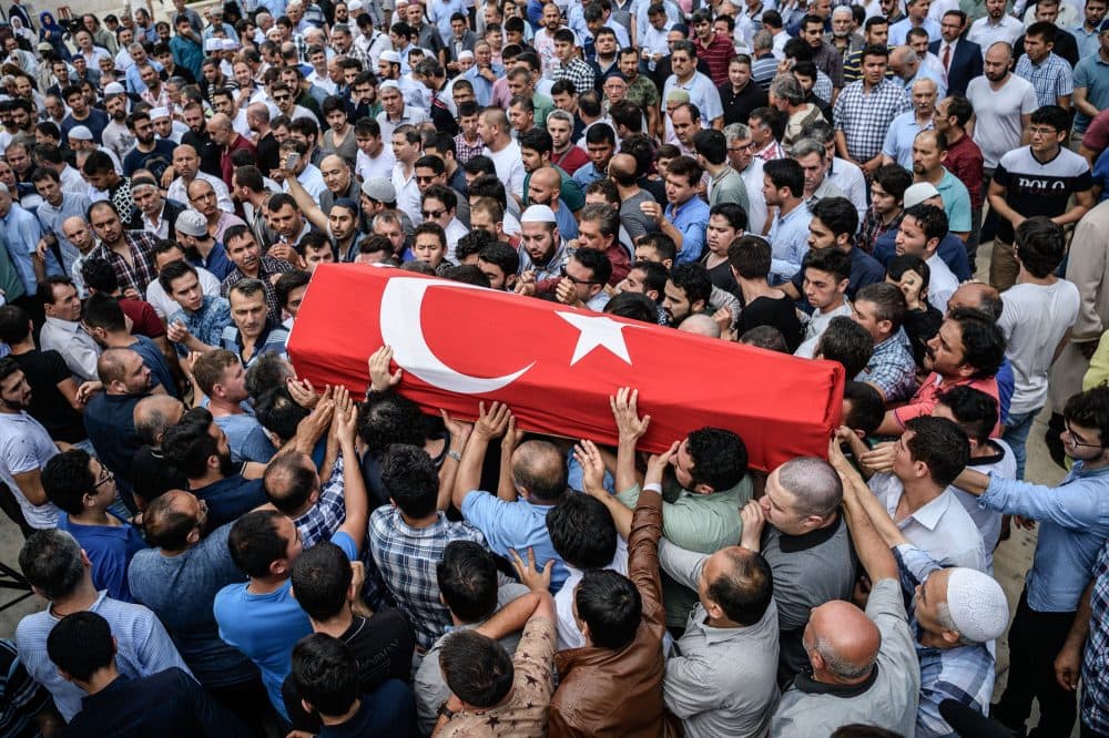 People carry a coffin covered with Turkish national flag of suicide attack victim Hamidullah Safar on June 30, 2016 in Istanbul during his funeral two days after a suicide bombing and gun attack targeted Istanbul's airport, killing at least 36 people. (Ozan Kose/AFP/Getty Images)