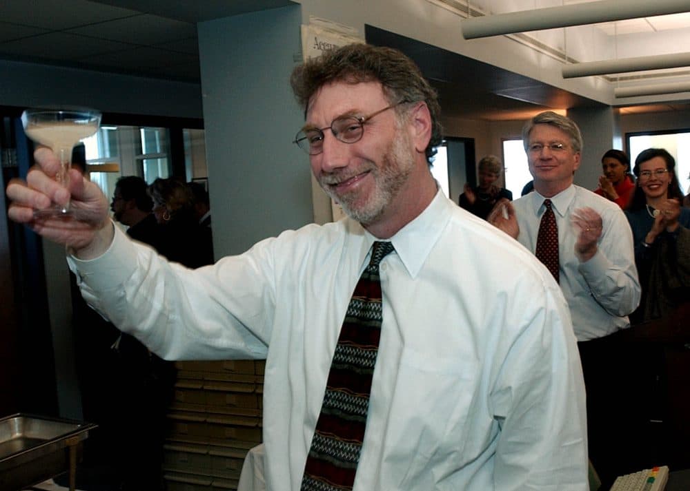 Then Boston Globe editor Martin Baron toasts reporters in the newsroom after the newspaper was honored as a recipient of a Pulitzer Prize in 2003.  (Charles Krupa/AP)