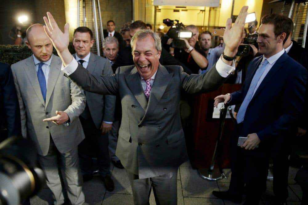 Nigel Farage, the leader of the UK Independence Party celebrates and poses for photographers as he leaves a &quot;Leave.EU&quot; organization party for the British European Union membership referendum in London, Friday, June 24, 2016. (Matt Dunham/AP)