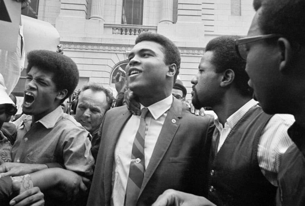 Muhammad Ali, center, leaves the Armed Forces induction center with his entourage after refusing to be drafted into the Armed Forces in 1967.  (AP Photo)