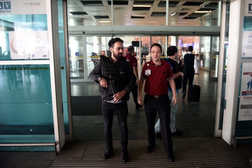 Security officials stand at an entrance of Ataturk Airport in Istanbul, Wednesday, June 29, 2016. (AP Photo)