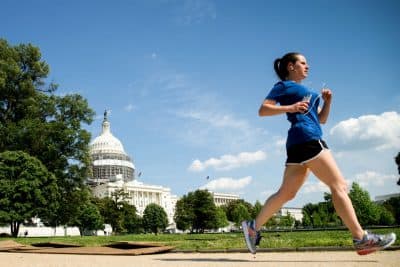 A woman jogs along the West Lawn on Capitol Hill in Washington, Tuesday, May 24, 2016, under blue skies after a recent rainy period. (AP Photo/Andrew Harnik)