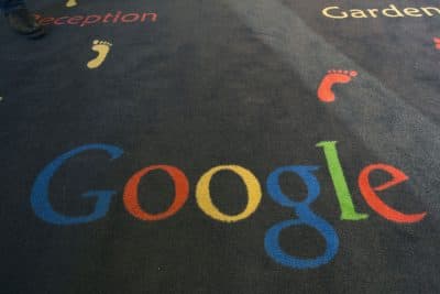 This Tuesday, Dec. 10, 2013 file photo shows the Google logo printed on a carpet during the inauguration of the new Google cultural institute in Paris, France. French police have raided Google's Paris offices as part of an investigation into &quot;aggravated tax fraud&quot; and money laundering, authorities said. (AP Photo/Jacques Brinon, File)