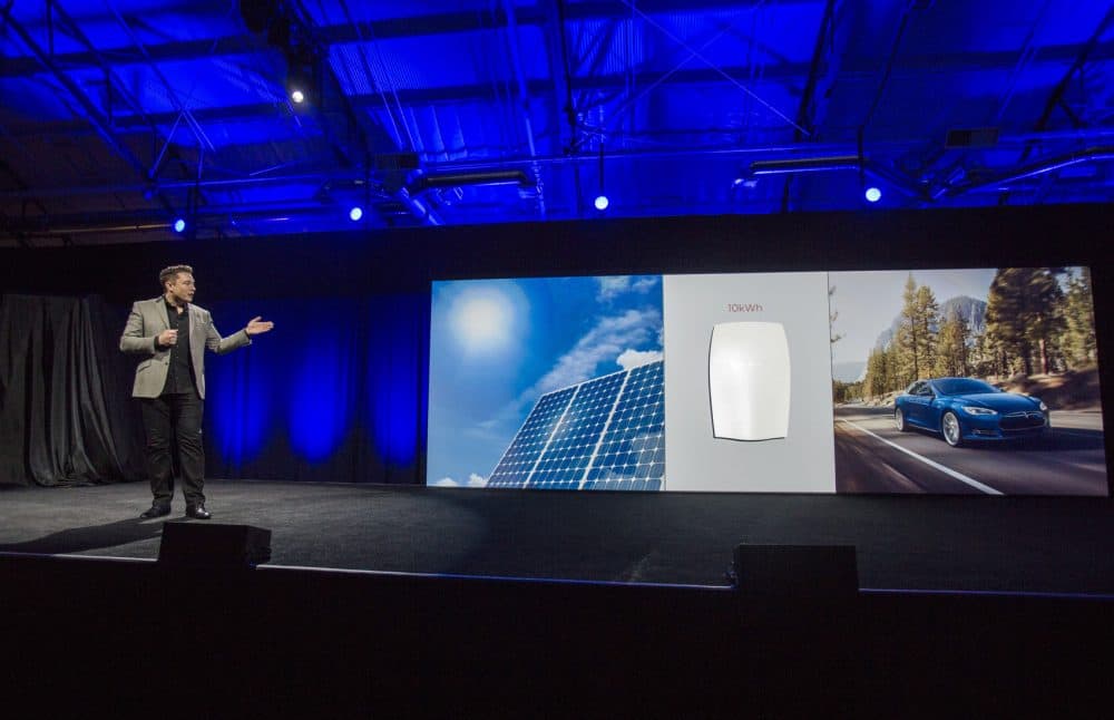 Elon Musk, CEO of Tesla Motors Inc., unveils the company's Powerwall home battery in April 2015. Vermont’s largest utility is selling Tesla's Powerwall to its customers -- both for the homeowner’s private use and for the utility to draw on as a source of electricity. Green Mountain Power is the first utility in the country to pilot the Powerwall in this way. (Ringo H.W. Chiu/AP)