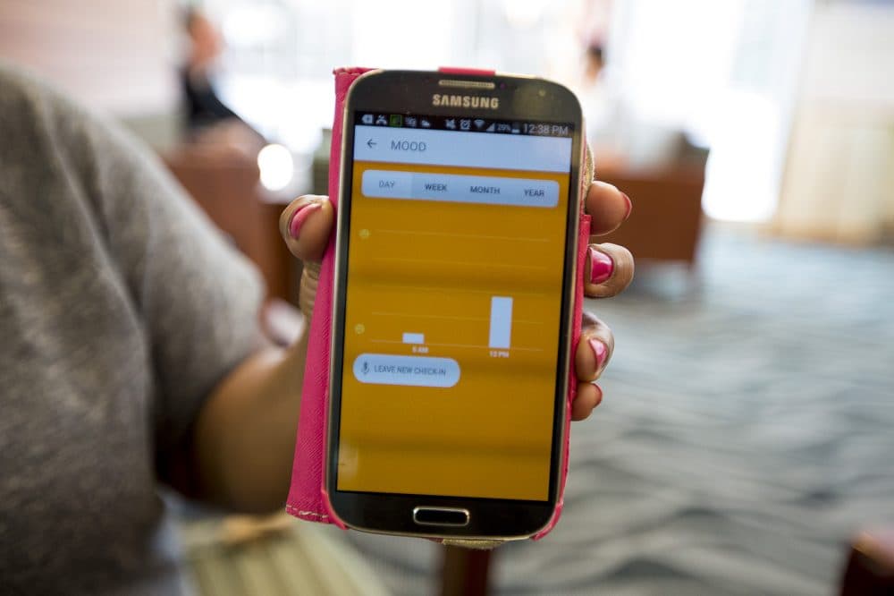A mobile phone displays the Cogito Companion app, which rates a patient's mood based on tone, pace and tension in his or her voice. (Jesse Costa/WBUR)