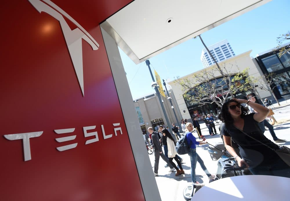 A woman looks into the Tesla store in Santa Monica, California on March 31, 2016. (Robyn Beck/AFP/Getty Images)