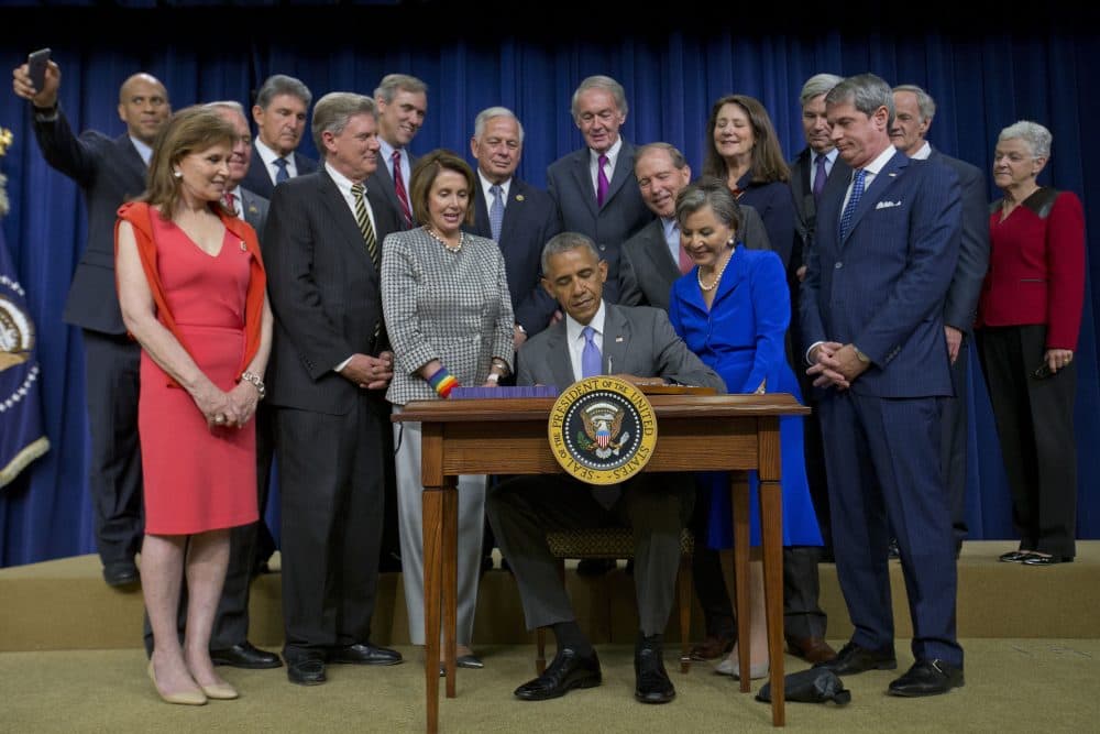 President Barack Obama, surrounded by members of Congress, signs bill H.R. 2576, the Frank R. Lautenberg Chemical Safety for the 21st Century Act., Wednesday, June 22, 2016, during a ceremony at the Eisenhower Executive Office Building on the White House complex in Washington. (Pablo Martinez Monsivais/AP)