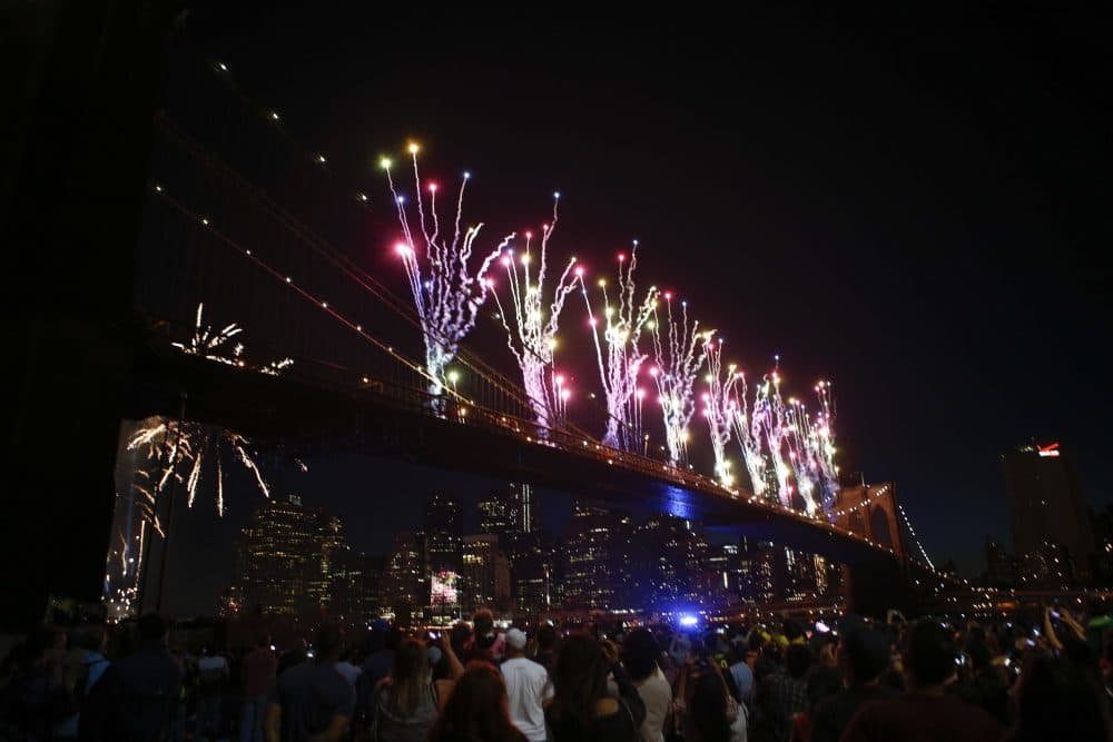 People gather to watch the annual Macy's fourth of July fireworks show looking over the East River on July 4, 2014 in the Brooklyn borough of New York City. The fireworks show returned to the East River for the first time since 2008. The United States marks 238 years as an independent nation as it celebrates the national holiday. (Kena Betancur/Getty Images)