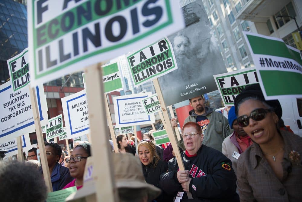 Demonstrators, protesting the state of Illinois budget stalemate, rally in the Loop before marching to the Chicago Board of Trade Building where they bolcked all of the entrances to the building on November 2, 2015 in Chicago, Illinois. (Scott Olson/Getty Images)