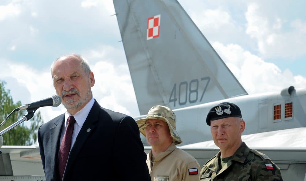 Polish Defense Minister Antoni Macierewicz speaks in front of a Polish Air Force F-16 fighter jet during a farewell ceremony of Polish soldiers leaving for Kuwait to take part in the operation Inherent Resolve, in Janow, Poland, Monday, July 4, 2016. (Alik Keplicz/AP)