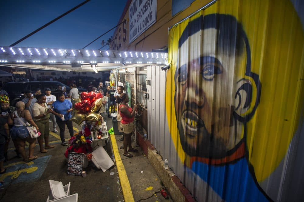 Protesters gather in front of a mural painted on the wall of the convenience store where Alton Sterling was shot and killed, July 6, 2016 in Baton Rouge, Louisiana. Sterling was shot by a police officer in front of the Triple S Food Mart in Baton Rouge on Tuesday, July 5, leading the Department of Justice to open a civil rights investigation. (Mark Wallheiser/Getty Images)