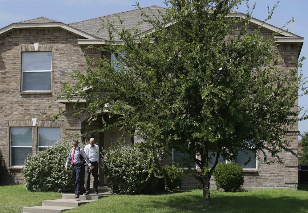 Investigators leave the home of Micah Xavier Johnson in the Dallas suburb of Mesquite, Texas, Friday, July 8, 2016. (LM Otero/AP)