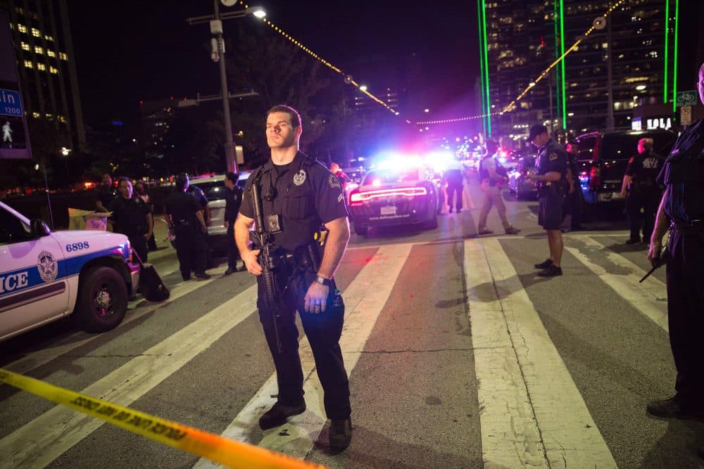 Police officers stand guard at a baracade following the sniper shooting in Dallas on July 7, 2016. (Laura Buckman/AFP/Getty Images)        