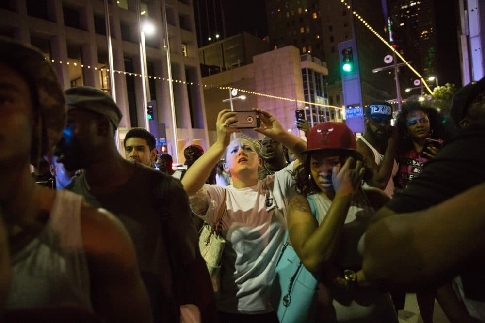 Protestors yell after police officers arrest a bystander following the shooting at a protest in Dallas on July 7, 2016. (Laura Buckman/Getty Images)
