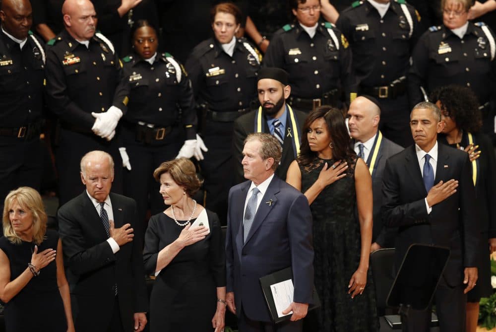 President Barack Obama, right, stands with first lady Michelle Obama, and former President George W. Bush, center, and Barbara Bush, during a memorial service at the Morton H. Meyerson Symphony Center with the families of the fallen police officers, Tuesday, July 12, 2016, in Dallas. Five police officers were killed and several injured during a shooting in downtown Dallas last Thursday night. (Eric Gay/AP)