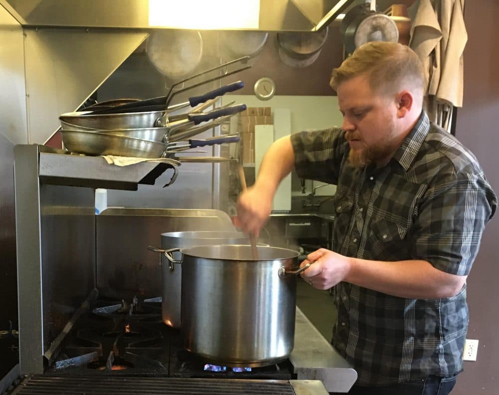 Brendan Vesey, chef at The Joinery restaurant in Newcastle, New Hampshire, makes stock from green crabs. (NHPR)