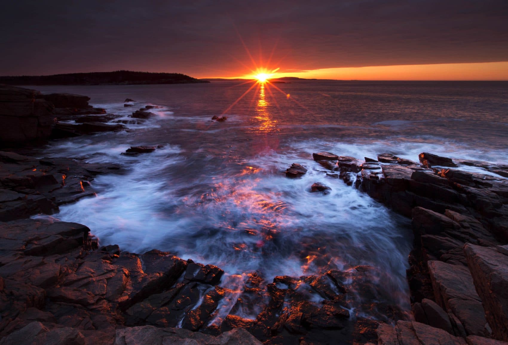 The sun's rays strike the rocky coast of Acadia National Park, in Maine, Thursday, May 2, 2013. (Robert F. Bukaty/AP)