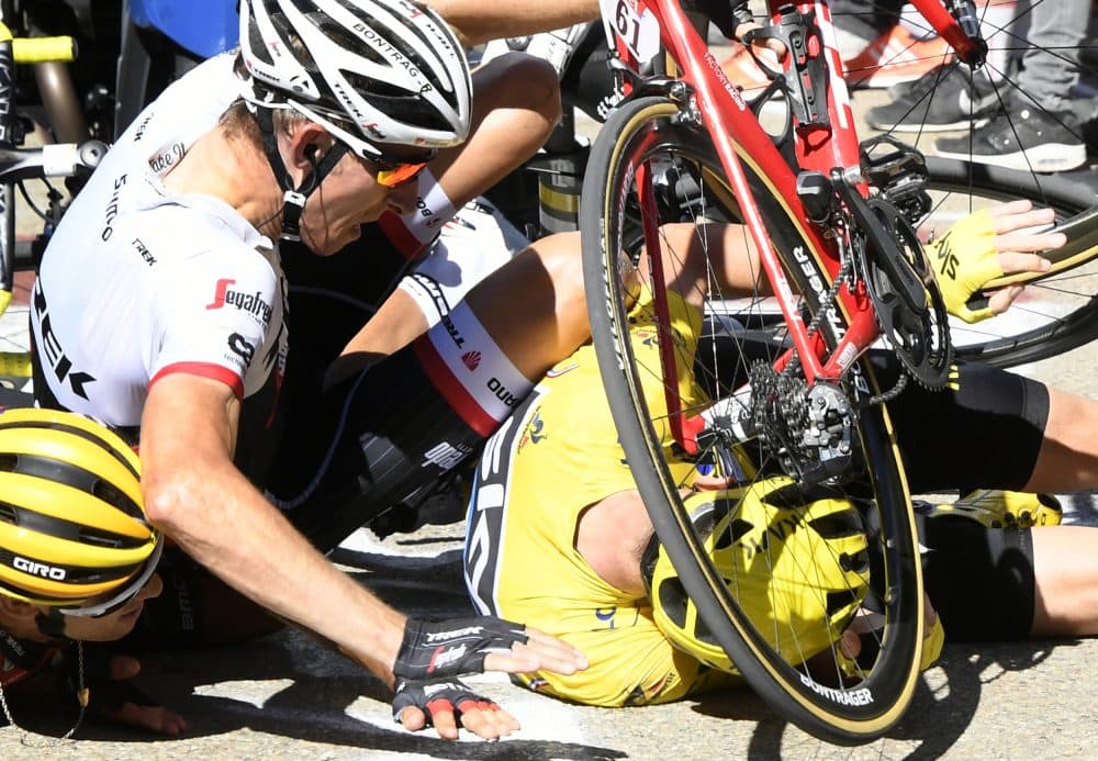 Britain's Chris Froome, wearing the overall leader's yellow jersey, right, Netherlands Bauke Mollema, center, and Australias Richie Porte crash at the end of the twelfth stage of the Tour de France cycling race in Mont Ventoux, France, Thursday, July 14, 2016. (Bernard Papon/Pool Photo via AP)