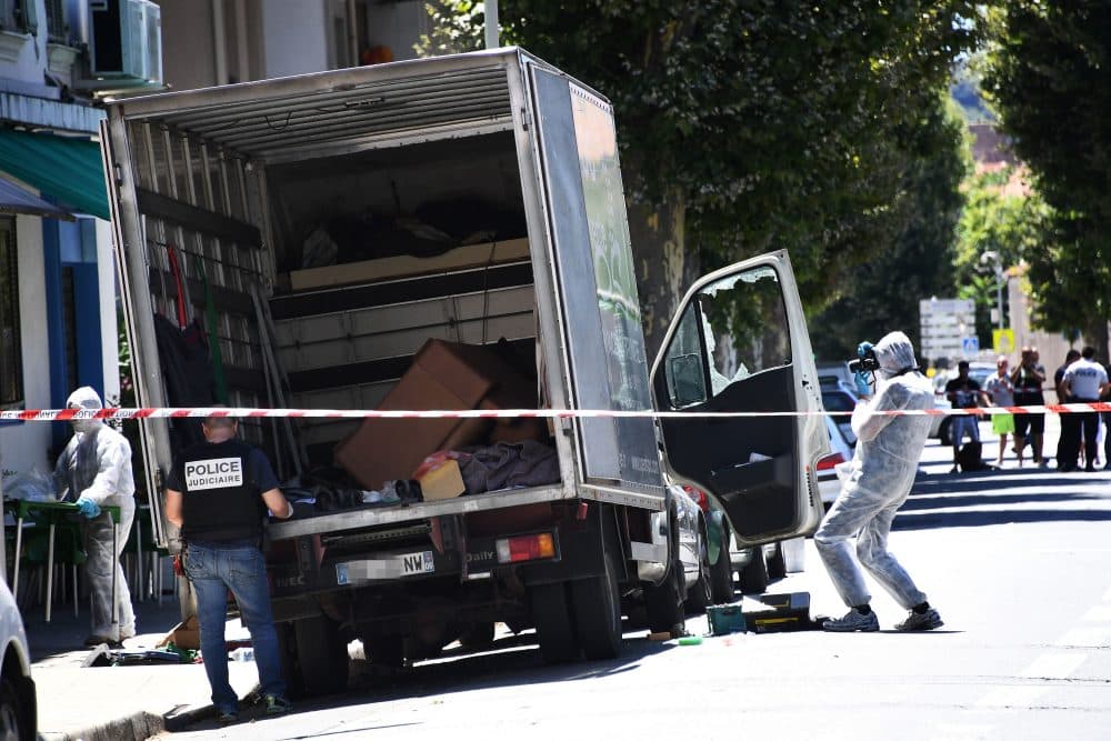 French police officers search a truck in a street of Nice on July 15, 2016, near the building where the man who drove a truck into a crowd watching a fireworks display the day before reportedly lived. (Anne-Christine Poujoulat/AFP/Getty Images)