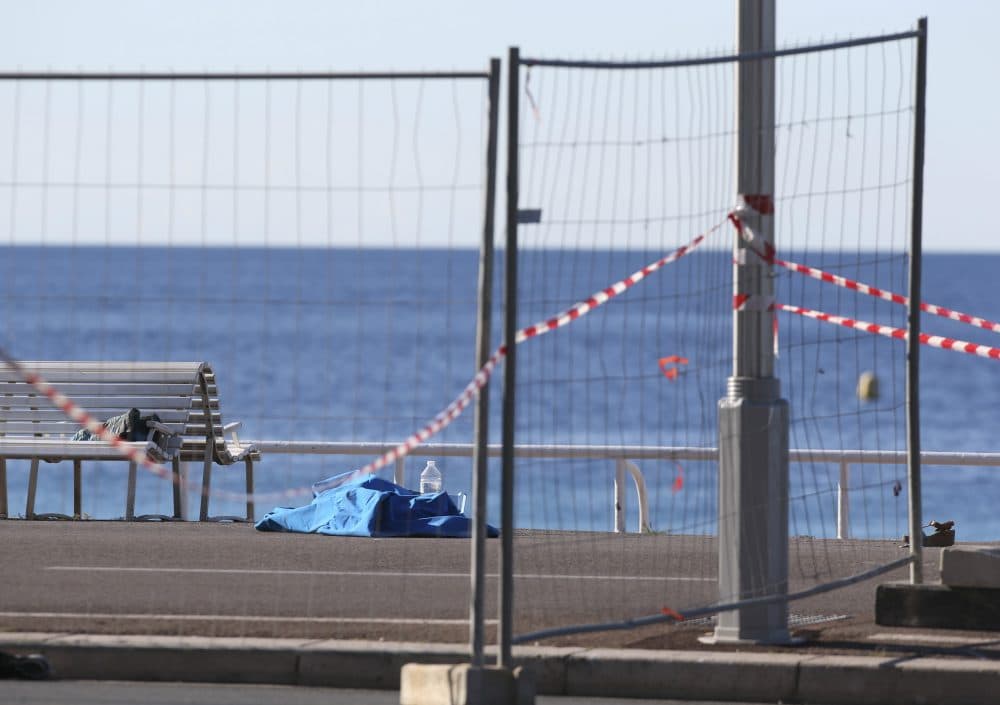 A body of a victim  covered by sheets lays at the scene of a truck attack in Nice, southern France, Friday, July 15, 2016. A large truck mowed through revelers gathered for Bastille Day fireworks in Nice, killing more than 80 people and sending people fleeing into the sea as it bore down for more than a mile along the Riviera city's famed waterfront promenade. (Luca Bruno/AP)