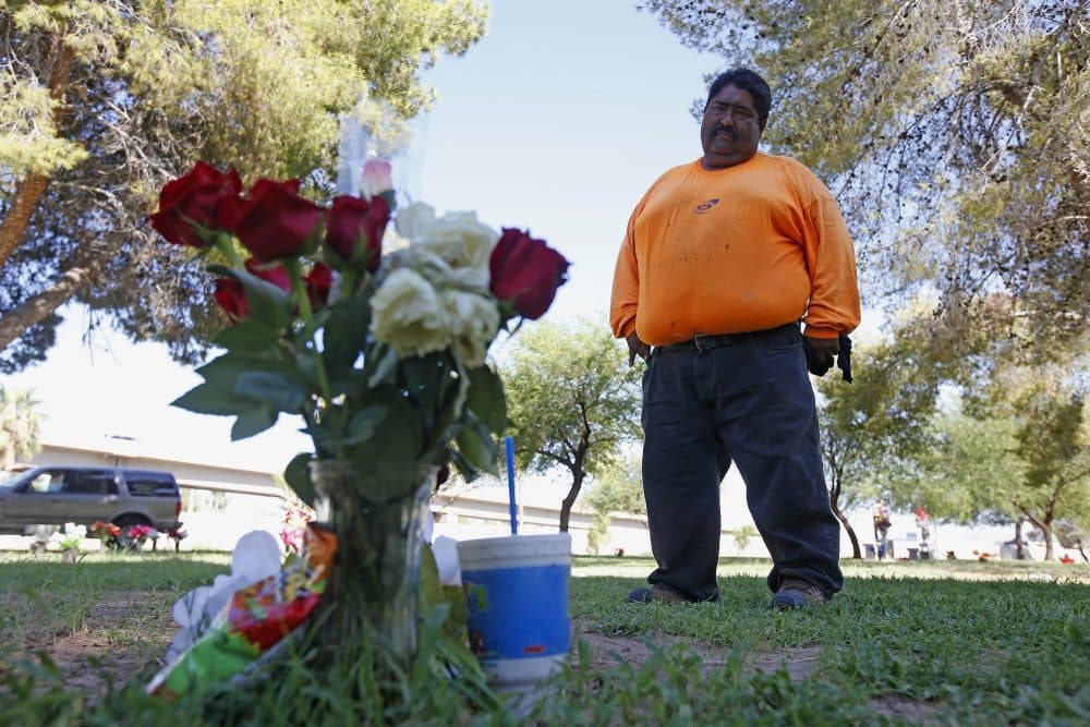 Margarito Castro, father of Manuel &quot;Manny&quot; Castro Garcia, 19, visits his son's grave at a cemetery Thursday, July 14, 2016, in Phoenix. The teen was killed in June, and is one of a growing number of victims associated with a serial killer according to police. (Ross D. Franklin/AP)