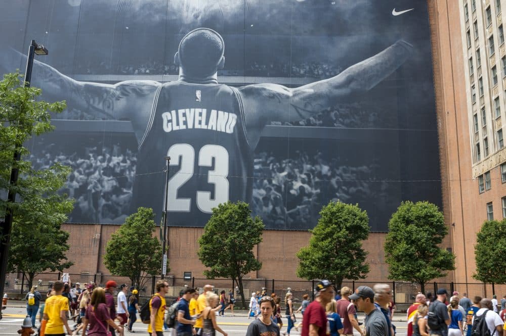Cleveland fans walk in front of a LeBron James mural located on Ontario St. during the Cleveland Cavaliers 2016 NBA Championship victory parade and rally on June 22, 2016 in Cleveland, Ohio. (Angelo Merendino/Getty Images)