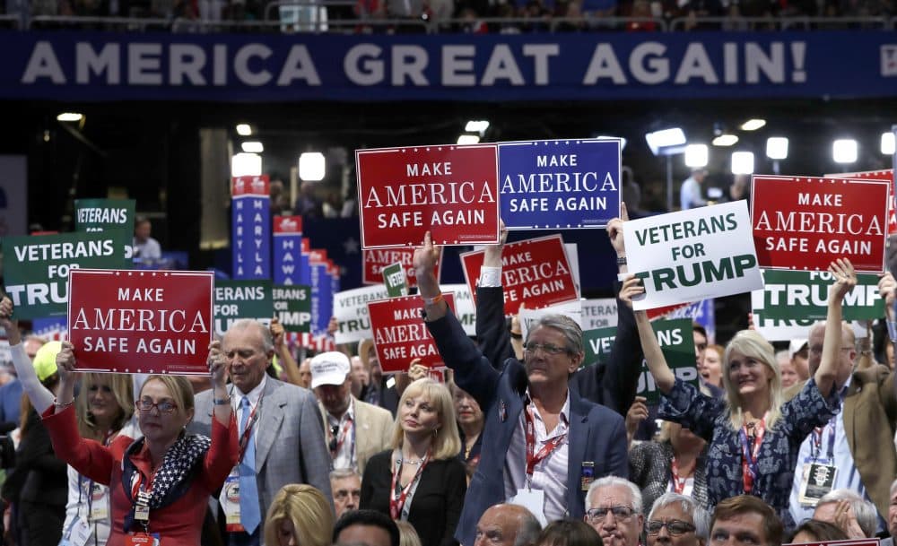 Delegates hold up signs and cheer Monday -- the first day of the Republican National Convention in Cleveland.(Carolyn Kaster/AP)