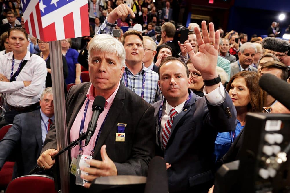 Sen. Mike Lee, (R-UT) and Phill Wright, Vice Chair of the Utah State Delegation (L) shout no to the adoption of rules without a roll call vote on the first day of the Republican National Convention on July 18, 2016 at the Quicken Loans Arena in Cleveland, Ohio. An estimated 50,000 people are expected in Cleveland, including hundreds of protesters and members of the media. The four-day Republican National Convention kicks off on July 18. (Chip Somodevilla/Getty Images)