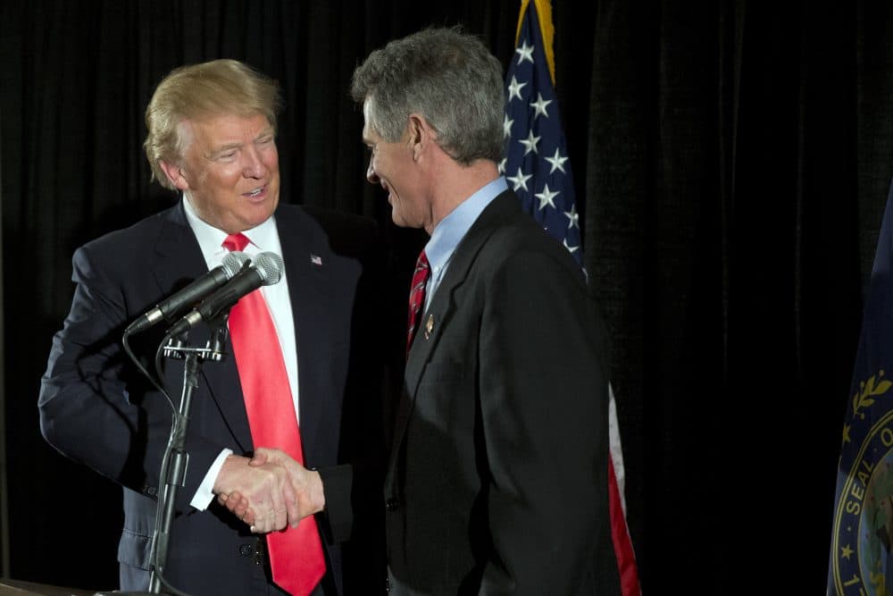 Former Massachusetts Sen. Scott Brown shakes hands with Republican presidential nominee Donald Trump in February. (Matt Rourke/AP)