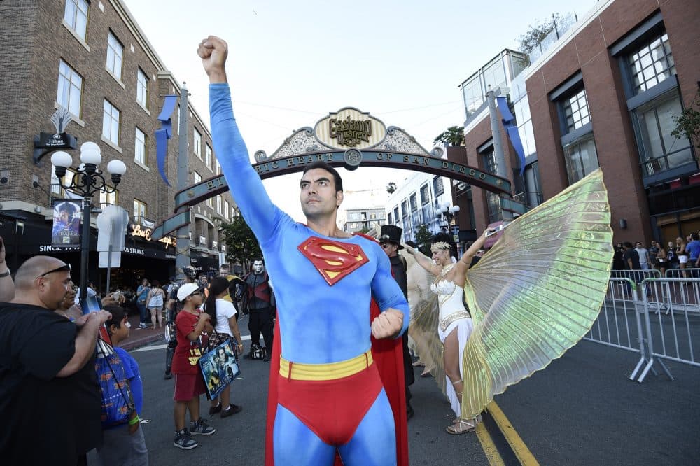 Sergio Valente, dressed as Superman, poses next to Isis Cress, dressed as the goddess Isis, outside on day one of Comic-Con International held at the San Diego Convention Center, Thursday, July 21, 2016 in San Diego. (Denis Poroy/Invision/AP)