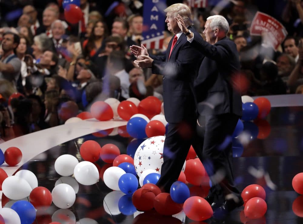 Republican presidential candidate Donald Trump walks with vice presidential candidate Gov. Mike Pence of Indiana as confetti and balloons fall during celebrations after Trump's acceptance speech on the final day of the Republican National Convention. (Matt Rourke/AP)