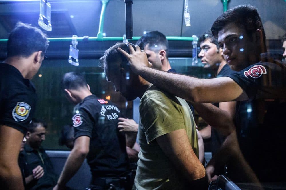 Turkish anti riot police officers detain a Turkish soldier who allegedly took part in a military coup as they are leaving in a bus the courthouse at Bakirkoy district in Istanbul on July 16, 2016. (Ozan Kose / AFP/Getty Images)