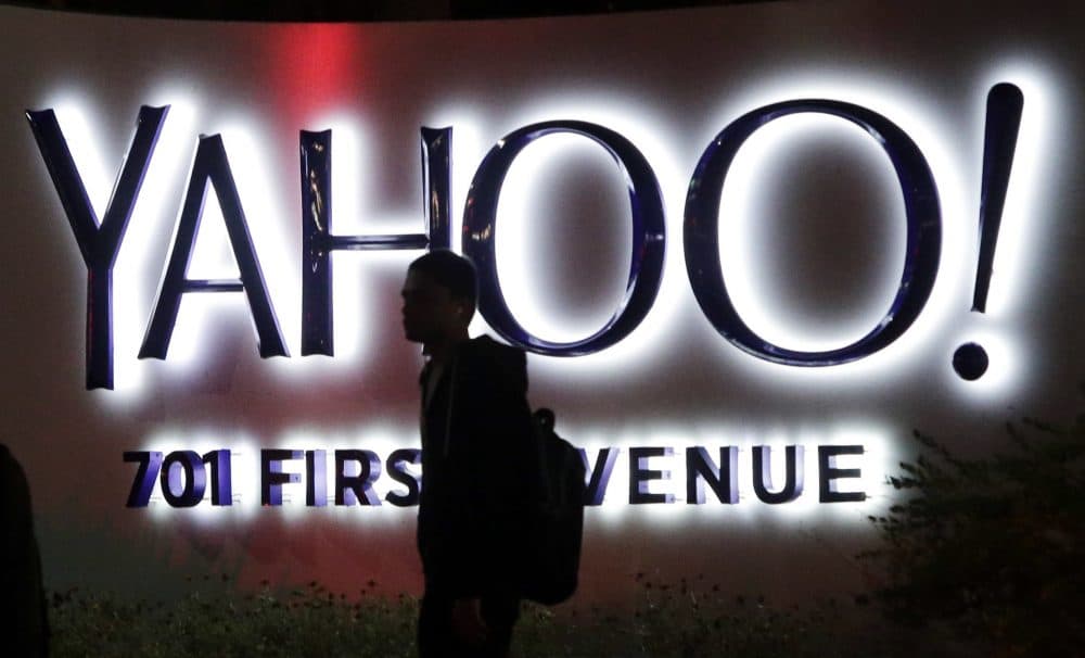 A person walks in front of a Yahoo sign at the company's headquarters in Sunnyvale, Calif. Verizon bought Yahoo in a sale announced Monday, July 25, 2016. (Marcio Jose Sanchez/AP)