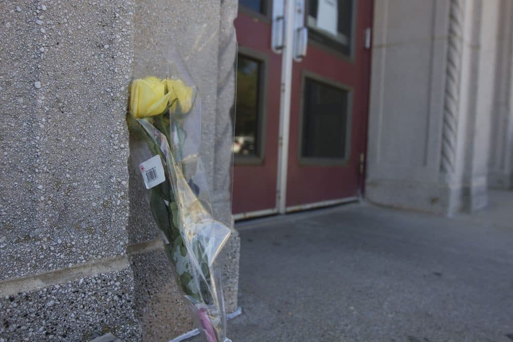 A lone flower is seen outside the Curley Community Center at Carson Beach in South Boston on Wednesday. The center's bathhouse is closed following the death of 7-year old Kyzr Willis. (Joe Difazio for WBUR)