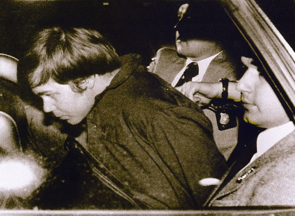 A March 30, 1981 file photo shows John Hinckley Jr. (L) escorted by police in Washington, D.C., following his arrest after shooting and seriously wounding then-President Ronald Reagan. (AFP/AFP/Getty Images)