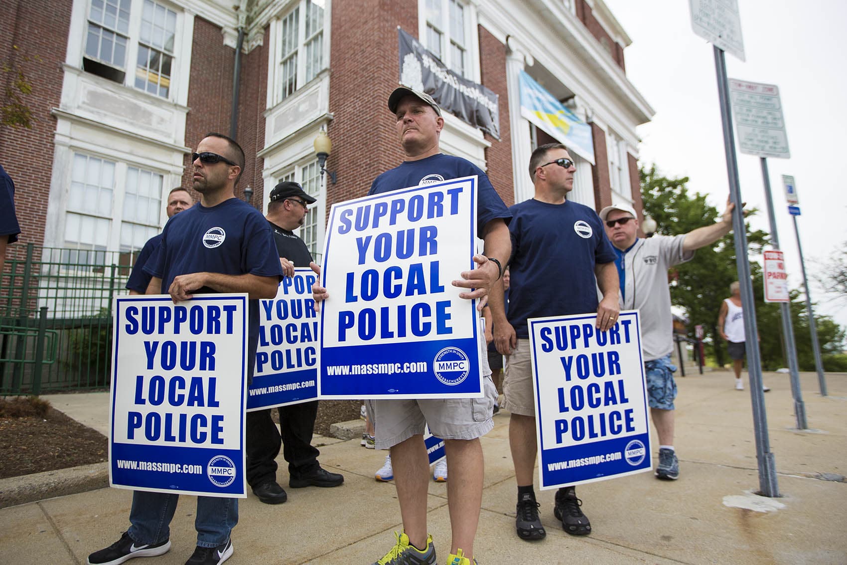Police officers rally in front of Somerville City Hall. A Black Lives Matter banner has been hanging outside of City Hall for a year, but now police are asking the mayor to take it down. (Jesse Costa/WBUR)