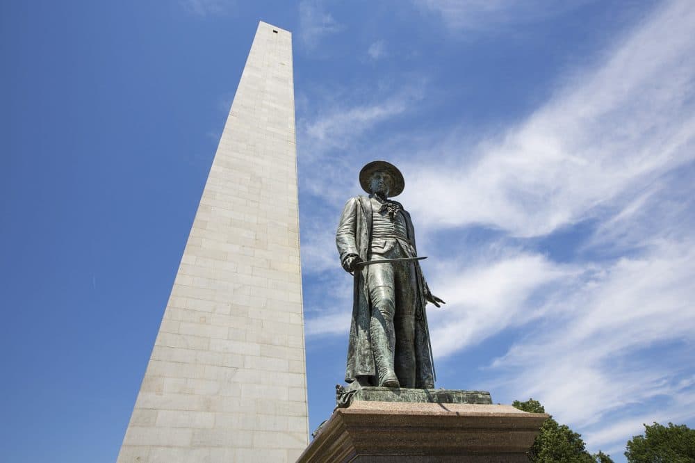The statue of Colonel William Prescott stands in front the of the Bunker Hill Monument in Charlestown. (Jesse Costa/WBUR)