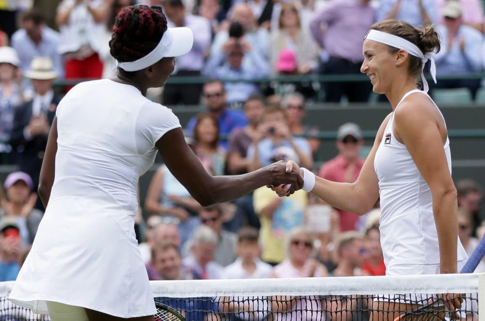 Venus Williams of the U.S, left, shakes hands with Yaroslava Shvedova of Kazahkstan after beating her in their women's singles match on day nine of the Wimbledon Tennis Championships in London, Tuesday, July 5, 2016. (AP Photo/Tim Ireland)