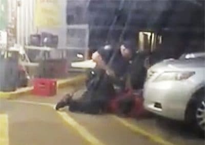 In this Tuesday, July 5, 2016 photo made from video, Alton Sterling is held by two Baton Rouge police officers, with one holding a hand gun, outside a convenience store in Baton Rouge, La. Moments later, one of the officers shot and killed Sterling, a black man who had been selling CDs outside the store, while he was on the ground. (Arthur Reed/AP)