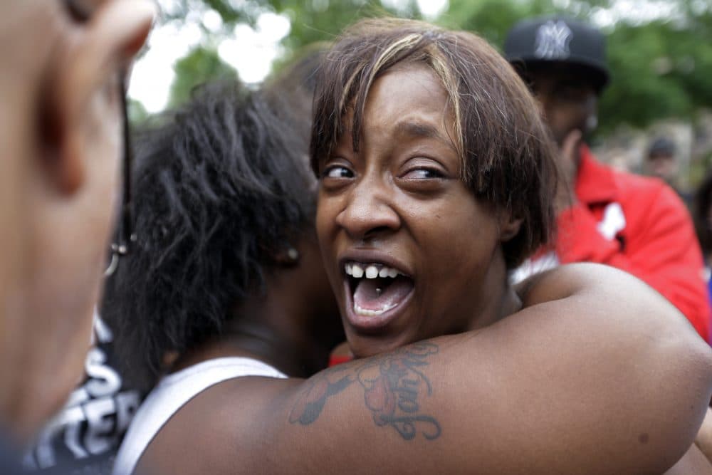 Diamond Reynolds, the girlfriend of Philando Castile, is consoled as she talks about his shooting death with protesters and media outside the governor's residence in St. Paul, Minn. Castile was shot and killed after a traffic stop by police in Falcon Heights Wednesday night. A video shot by Reynolds of the shooting  went viral. (Jim Mone/AP)