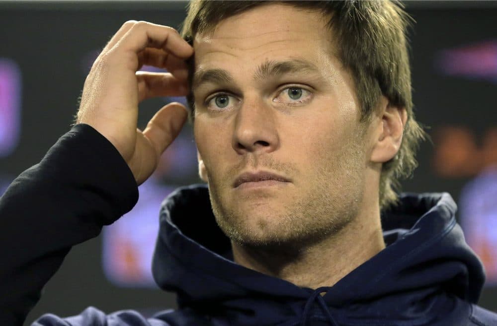 Tom Brady faces reporters before practice in Foxborough earlier this year. The Patriots quarterback announced Friday he would drop his appeal and serve his four-game suspension for the &quot;Deflategate&quot; scandal. (Steven Senne/AP)