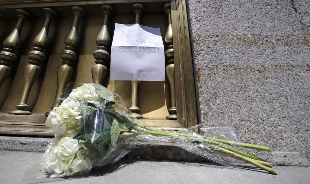 A bouquet of flowers and a note wishing &quot;Nice Strong&quot; were left outside the entrance to the French Consulate in Boston. (Charles Krupa/AP)