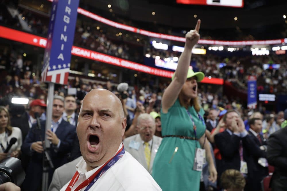 Illinois delegate Christian Gramm, left, and other delegates react as some call for a roll call vote on the adoption of the rules during first day of the Republican National Convention in Cleveland. (John Locher/AP)