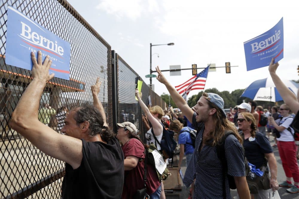 Supporters of Bernie Sanders show signs to Democratic National Convention goers during a protest Monday in Philadelphia. (Matt Slocum/AP)