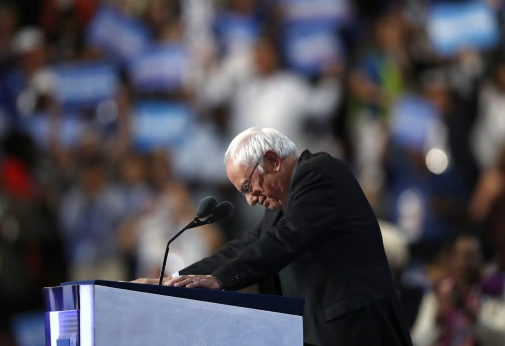 Former Democratic Presidential candidate, Sen. Bernie Sanders, I-Vt., stands at the podium as he is greeted by massive applause during the first day of the Democratic National Convention in Philadelphia , Monday, July 25, 2016. (Paul Sancya/AP)