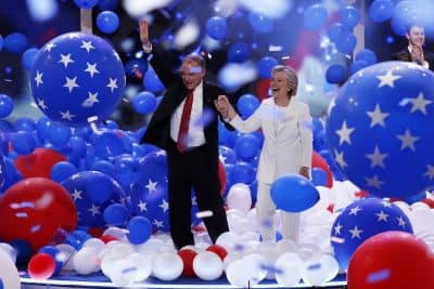 Democratic vice presidential nominee Virginia Sen. Tim Kaine and Democratic presidential nominee Hillary Clinton walk through the falling balloons during the final day of the Democratic National Convention in Philadelphia. (J. Scott Applewhite/AP)