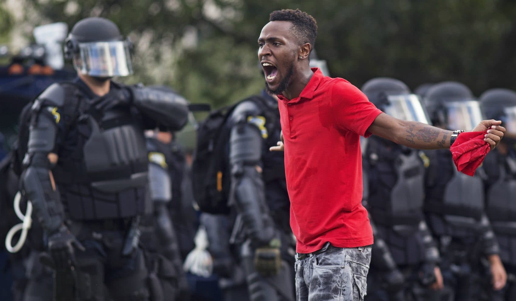 A protester yells at police in front of the Baton Rouge Police Department headquarters after police arrived in riot gear to clear protesters from the street in Baton Rouge, La., Saturday, July 9, 2016. Several protesters were arrested. (Max Becherer/AP)
