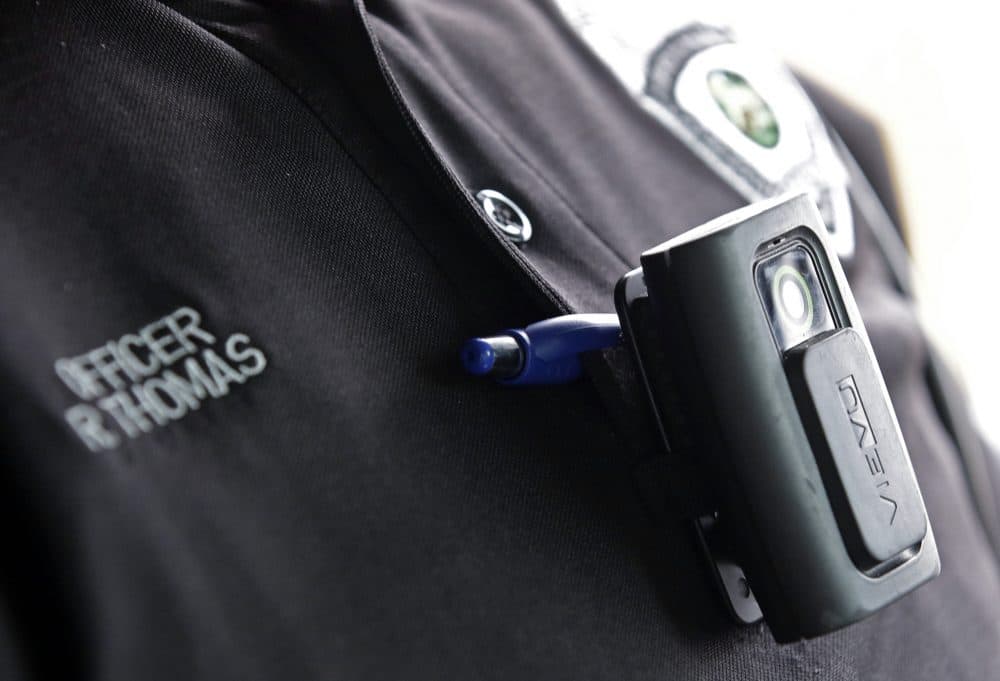 After recent police shootings, activists in Boston say they want police to move more quickly in implementing a body camera pilot program. Pictured: A body camera on an officer in Whitestown, Indiana. (Darron Cummings/AP)