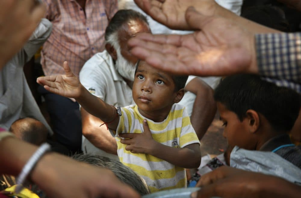 Joelle Renstrom: &quot;People who struggle to meet basic needs such as food, water, shelter and security have bigger concerns than internet access.&quot;
Pictured: An Indian child stretches arms to receive free food being distributed outside a Hindu temple, in New Delhi, India, where countless children live with grinding poverty, sleep on sidewalks, beg at traffic intersections and rely on government-run lunch programs that often provide their only full meal for the day. (Manish Swarup/AP)