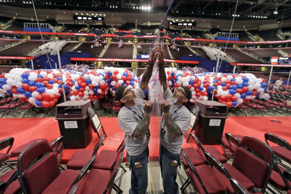 Wesley Baesel, from Cleveland, removes the protective coating from a mirror covered camera stand, as preparations are made for the Republican National Convention at the Quicken Loans Arena in Cleveland, Ohio. (Alex Brandon/AP)